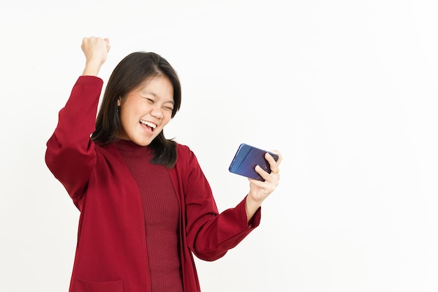 Playing Mobile Game on Smartphone Of Beautiful Asian Woman Wearing Red Shirt Isolated On White