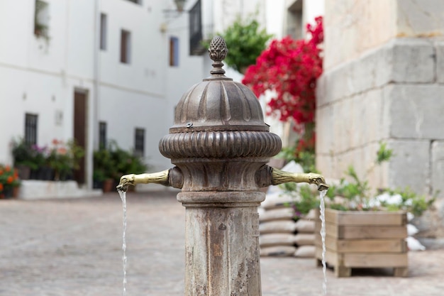 Plaza with fountain of two pipes in Ain Castellon Spain