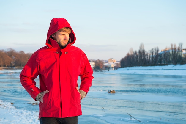 Pleasant thoughts. weather forecast. human and nature. man walking snowy landscape in sunset. travel and expedition concept. man in red parka. winter male fashion. warm clothes for cold climate.