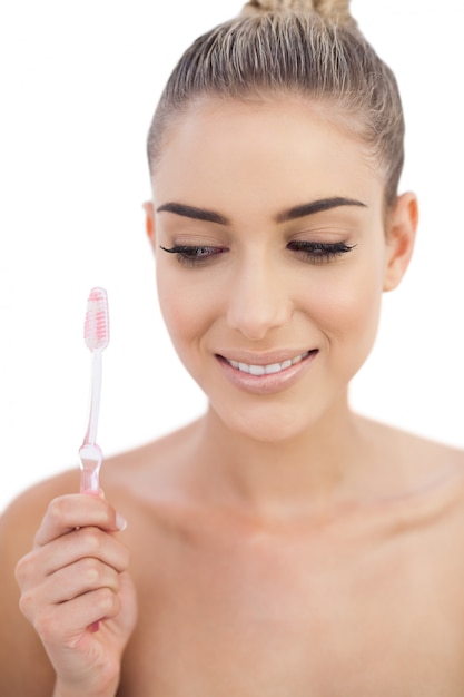 Pleased woman holding a toothbrush