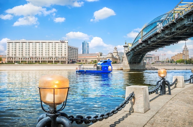 Pleasure ship of blue color on the Moskva River and Bogdan Khmelnitsky bridge Moscow