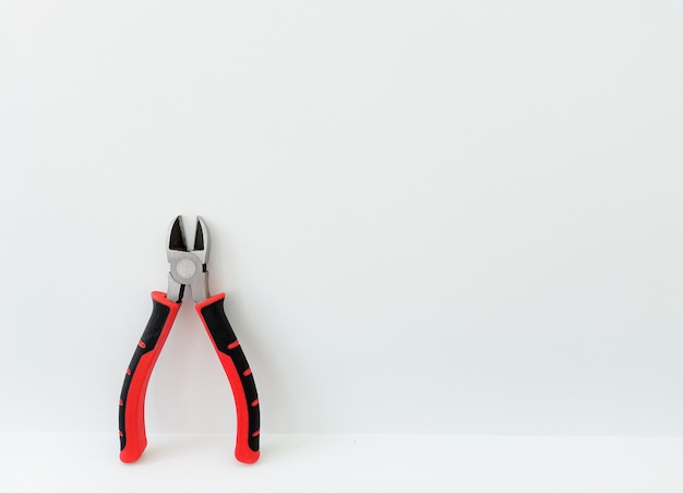 pliers wire cutters in bright colors on isolated white background string construction tools