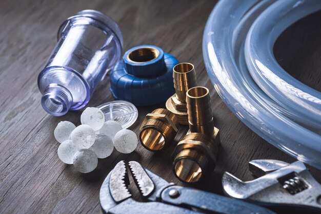 Plumbing Different wrenches pipe tube fittings and connectors on a wooden rustic table