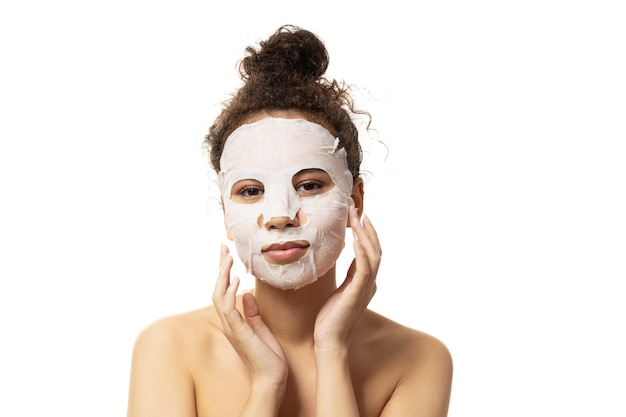 PNGattractive girl in a cosmetic mask on her facet isolated on white background