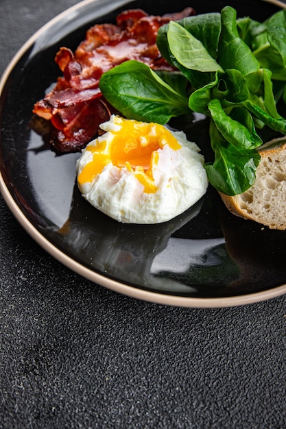 poached egg breakfast bacon, green leaves salad mix healthy meal food snack on the table copy space