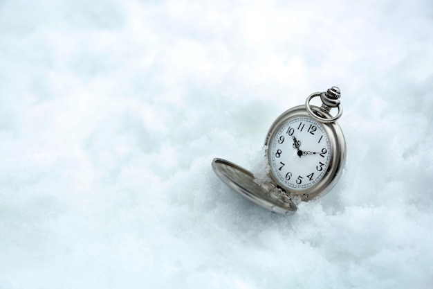 Pocket watch over white snow