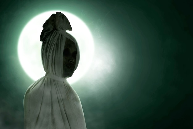 Pocong is covered with a white linen shroud standing