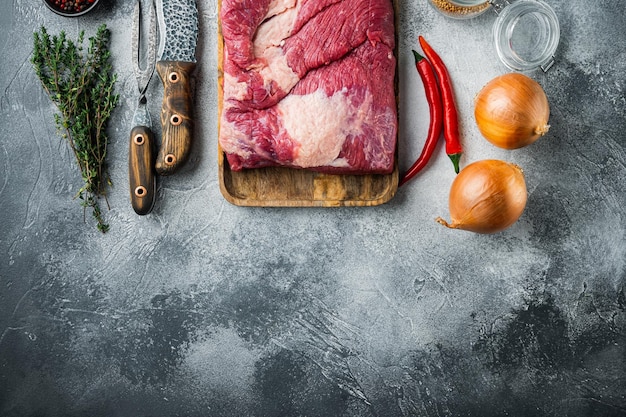 Point brisket raw beef brisket meatwith ingredients for smoking making barbecue pastrami cure on gray stone background top view flat lay with copy space for text