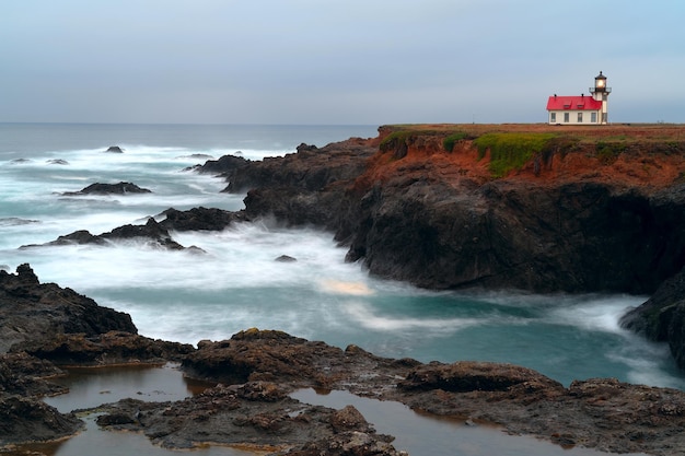 Point Cabrillo Lighthouse on a cliff surrounded by the Pacific Ocean in California, the USA