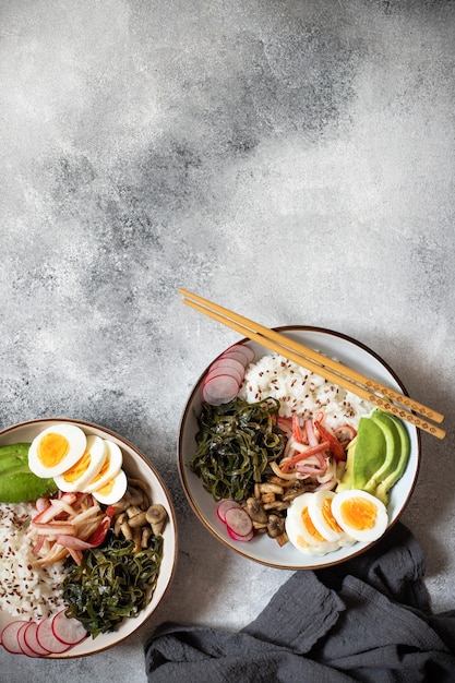 Poke bowl with crab, rice, avocado and egg