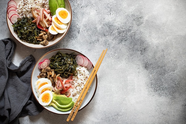 Poke bowl with crab, rice, avocado and egg