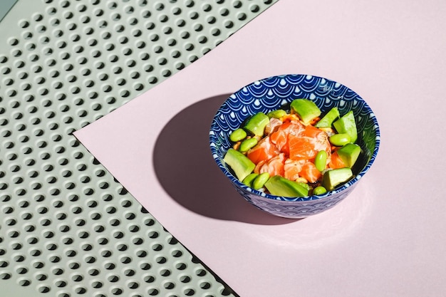 Poke bowl with rice avocado edamame beans and smoked salmon hard light deep shadow