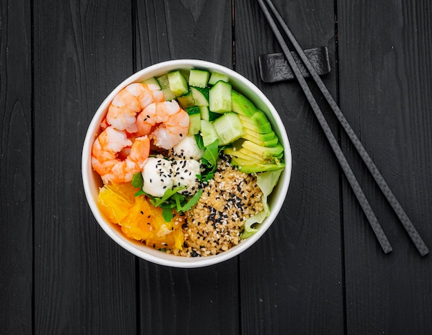 Poke bowl with shrimp quinoa avocado cucumber cream cheese and orange