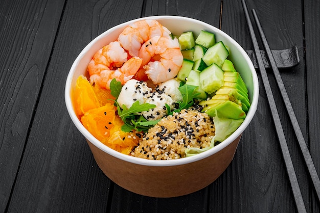 Poke bowl with shrimp quinoa avocado cucumber cream cheese and orange