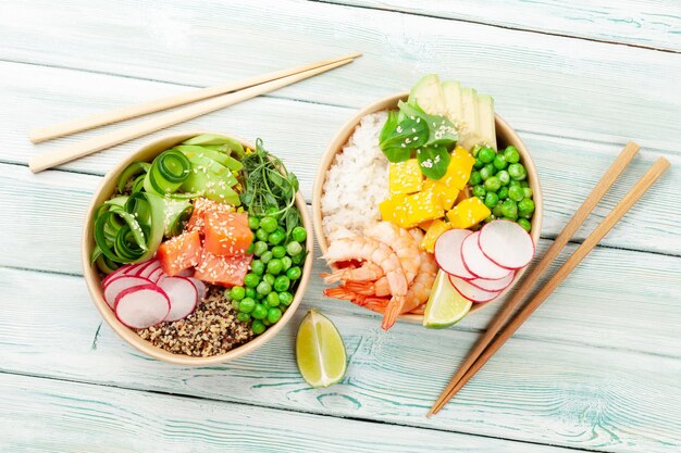 Poke bowls with shrimps salmon avocado and mango