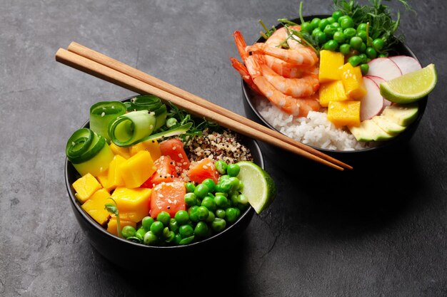 Poke bowls with shrimps salmon avocado and mango