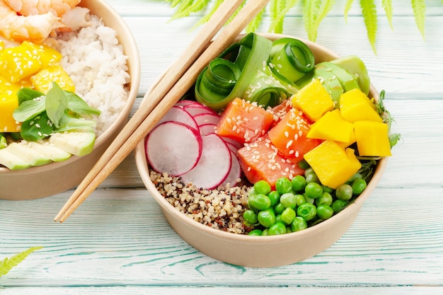 Poke bowls with shrimps salmon avocado and mango