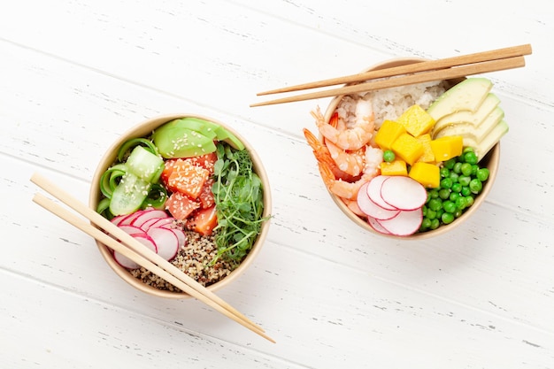 Poke bowls with shrimps salmon avocado and mango