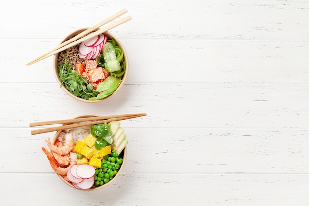 Poke bowls with shrimps salmon avocado and mango