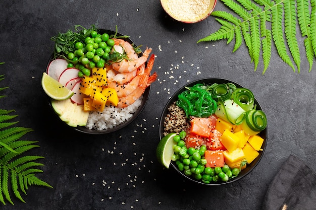 Poke bowls with shrimps salmon avocado and mango