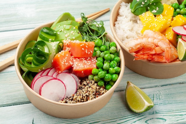 Poke bowls with shrimps salmon avocado and mango