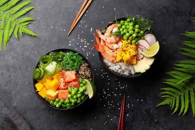 Poke bowls with shrimps salmon avocado and mango