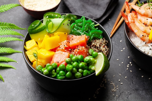 Poke bowls with shrimps salmon avocado and mango