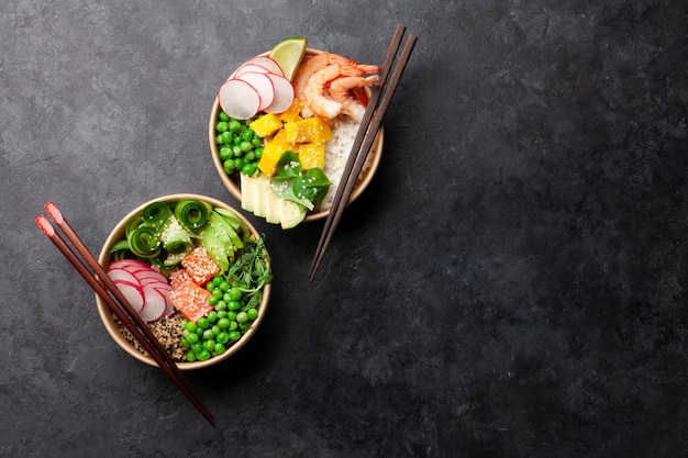 Poke bowls with shrimps salmon avocado and mango