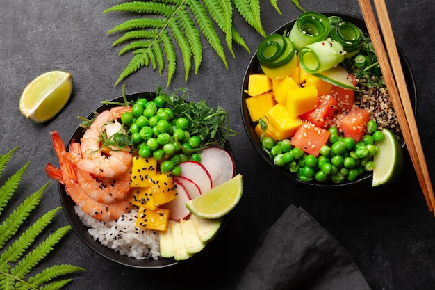 Poke bowls with shrimps salmon avocado and mango