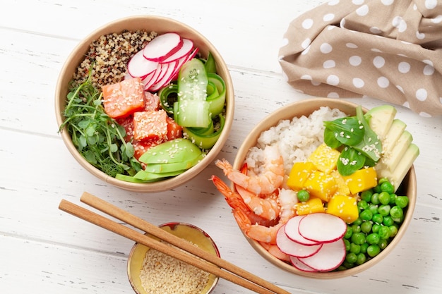 Poke bowls with shrimps salmon avocado and mango