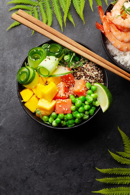 Poke bowls with shrimps salmon avocado and mango