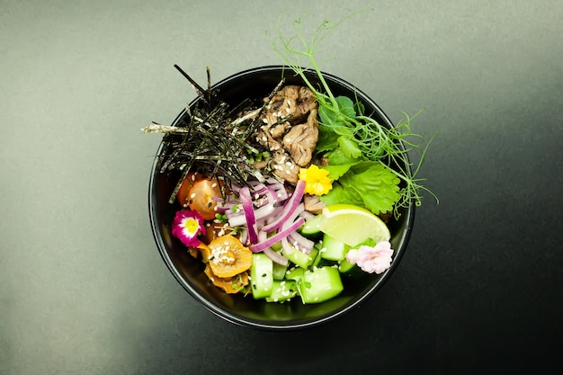 Poke salad with beef in a bowl ingredients beef nameko mushrooms cherry tomatoes rice cucumber red