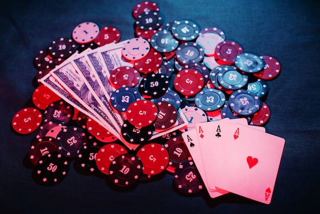 Poker chips are stacked as a bet near cards