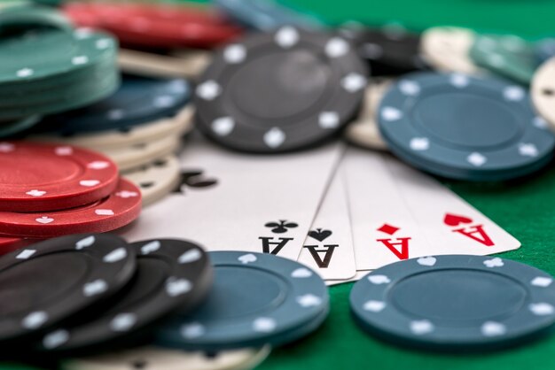 Poker chips and cards on a green background