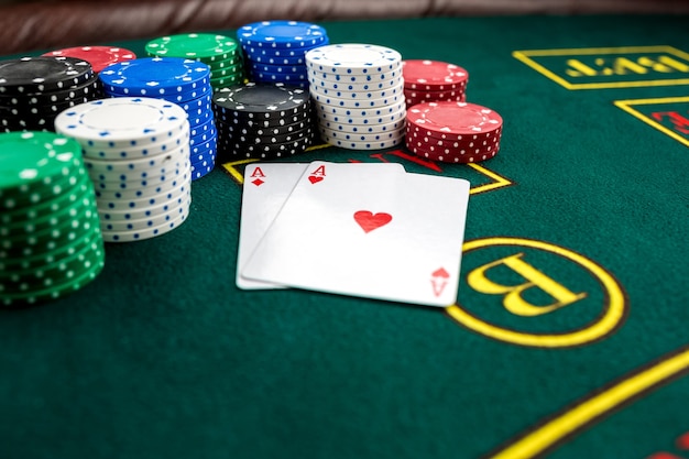 Poker play. Chips and cards on the green table