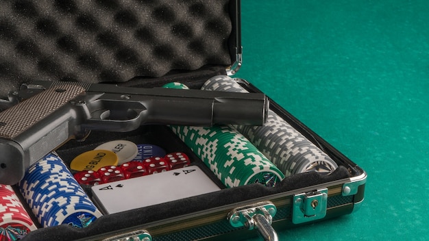 Poker set with a gun. The concept of gambling and entertainment. Casino and poker