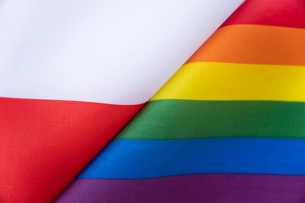 Poland flag and flag of the LGBT community The problem of the rights of sexual minorities in the country Protection and infringement of human rights nontraditional relations and politics concept