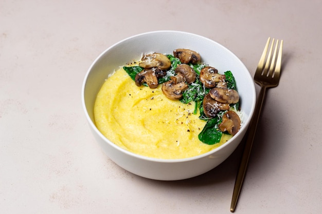 Polenta with mushrooms spinach and cheese Healthy eating Vegetarian food Italian cuisine