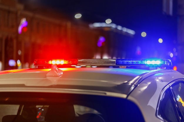 Police car lights at night in city with selective focus and bokeh