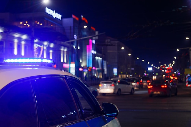 Police car lights in night city with selective focus and bokeh