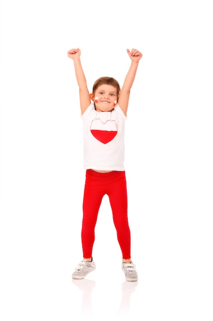 a Polish little girl in national colors smiling over white