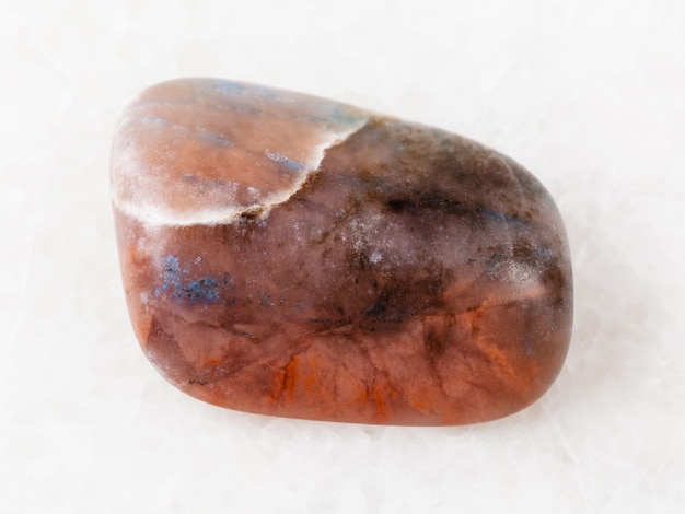 Polished Irnimite gemstone on white