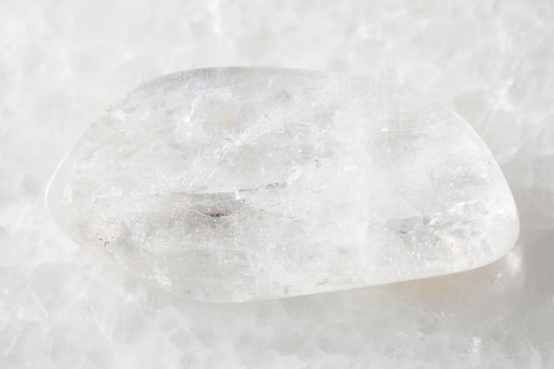 Polished Natrolite gemstone on white