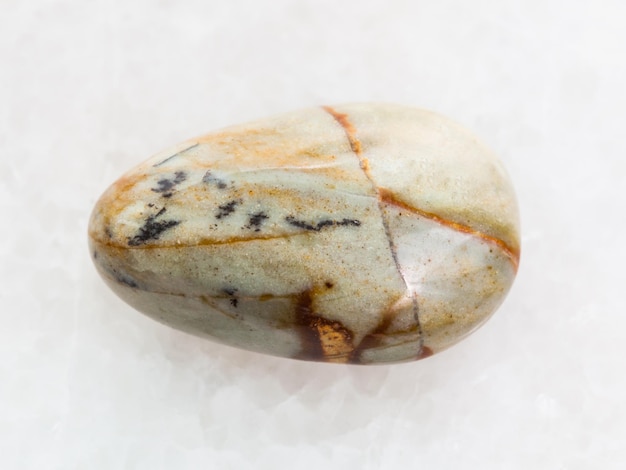 Polished Picture jasper gemstone on white marble