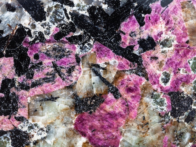 Polished syenite stone with eudialyte and aegirine