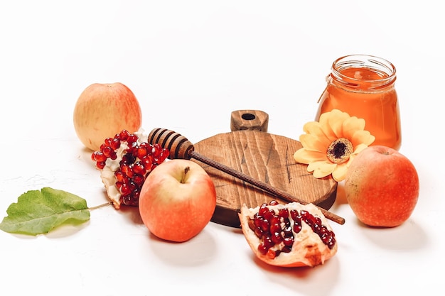 Pomegranate apples and honey Autumn composition Traditional Jewish holiday New Year Happy Rosh Hashanah