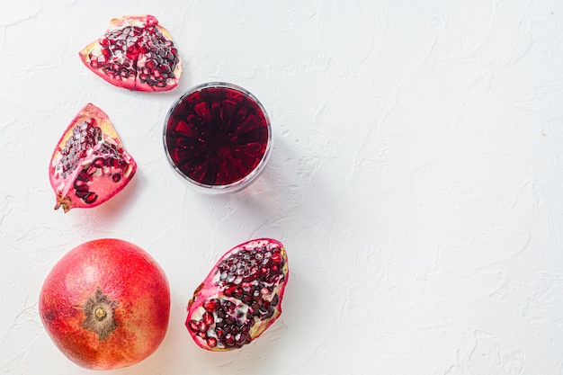 Pomegranate juice in glass with cuts and whole garnet