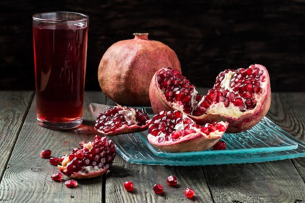 Pomegranate juice and slices of pomegranate with grains