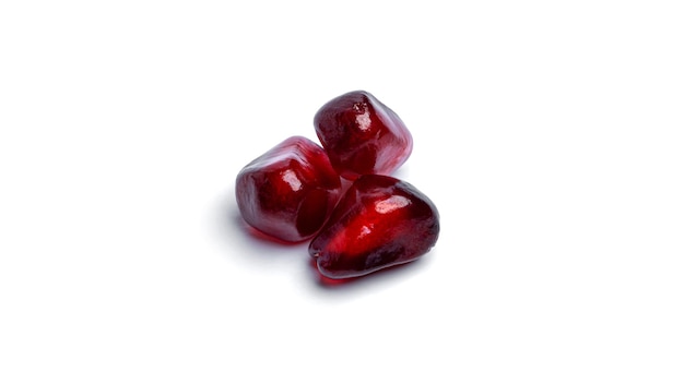 Pomegranate seeds on white background