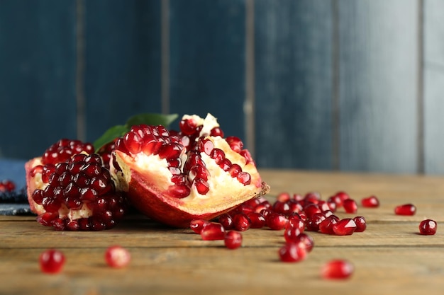 Pomegranate seeds on wooden table closeup